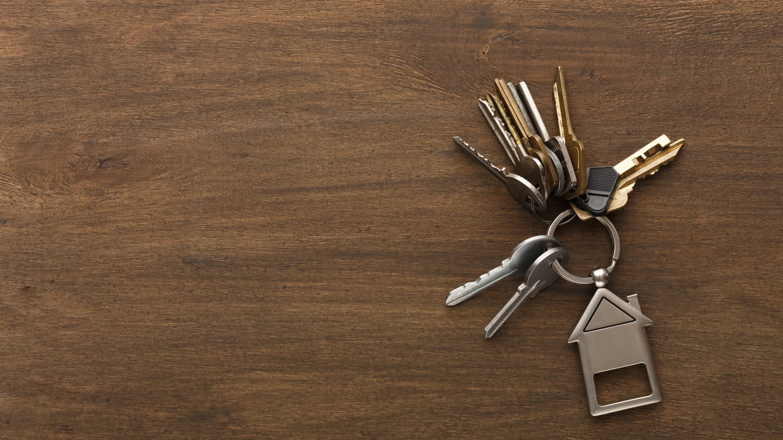 A set of house keys being handed over, symbolizing a successful and secure rental agreement.